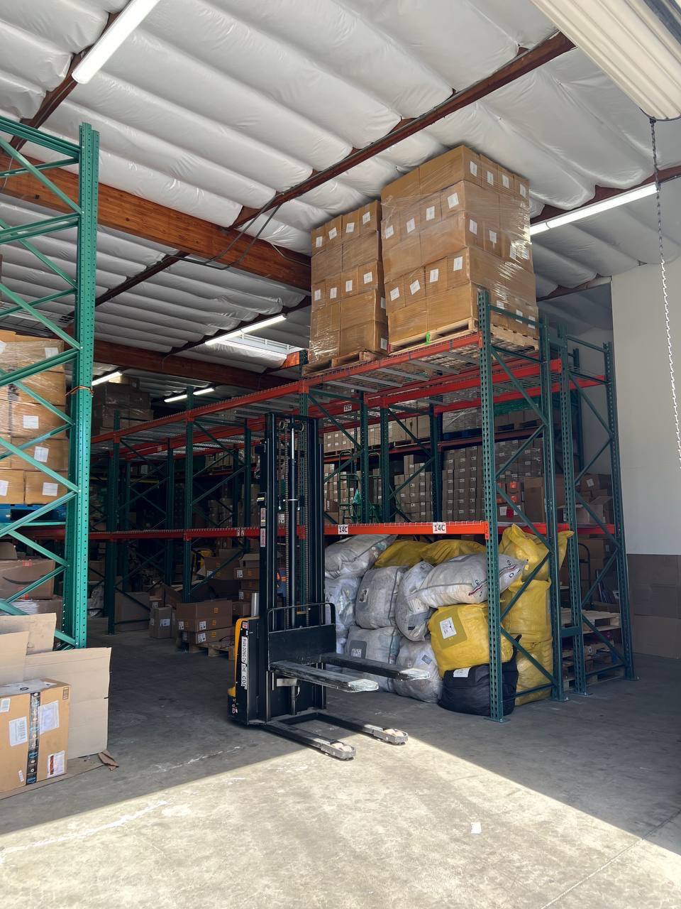 Pallets of cartons stored on warehouse racking